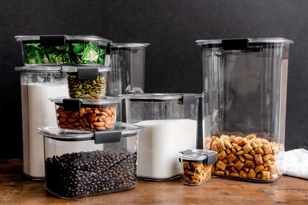 Well-structured pantry showcasing clear containers, stacked bins, and categorized food items for efficient storage