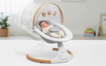 Jool Baby Nova Nature electric baby swing with newborn calmly swaying side to side under canopy