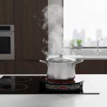 Modern kitchen with sleek induction cooktop heating a pot quickly for efficient cooking
