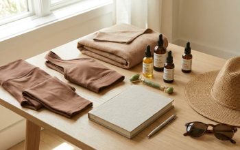 Luxury wellness retreat packing essentials laid out neatly including yoga wear, skincare, and journal