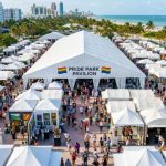 Aerial view of Pride Park pavilion tent at Miami Beach during the fair with visitors exploring gallery booths