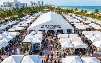 Aerial view of Pride Park pavilion tent at Miami Beach during the fair with visitors exploring gallery booths