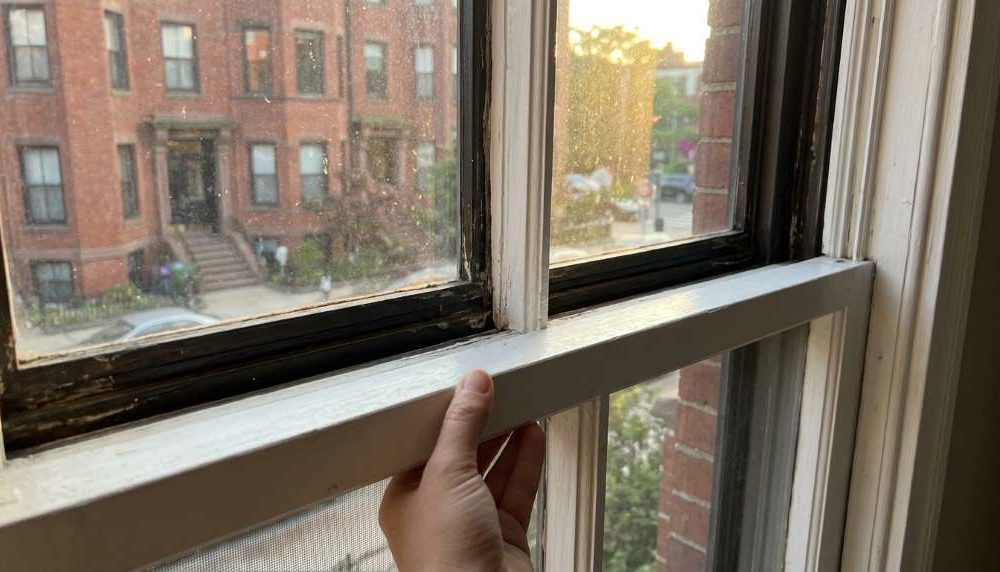 Tight wooden window frame repair in Boston home