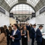 Trade buyers and jewellery designers browsing fine jewellery exhibitor stands at the Jewellery Show London 2026 inside the National Hall at Olympia