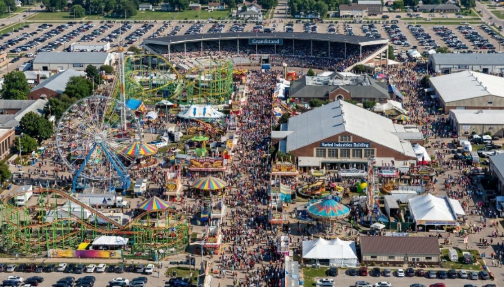Aerial view of the Iowa State Fair 2026 grounds in Des Moines with crowds and fairground rides