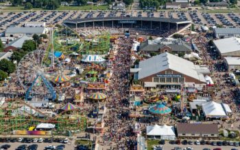 Aerial view of the Iowa State Fair 2026 grounds in Des Moines with crowds and fairground rides