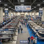 Rows of bass boats and pontoon boats on display at the KC Boat and Fishing Show 2027 indoor exhibit hall