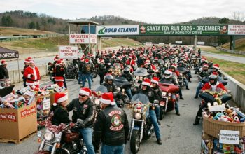 Motorcycle riders in Santa hats gathered at Road Atlanta for the Santa Toy Run 2026 toy drive event in December
